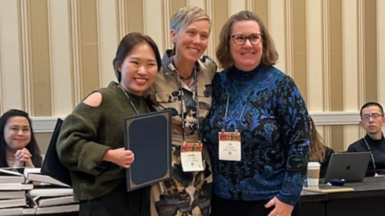 Jessica Ryu and Shelly Hovick posing for picture with top paper award at NCA 2023.