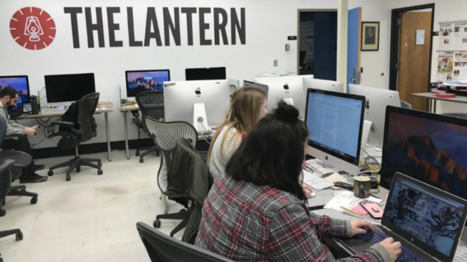 Students work in The Lantern newsroom