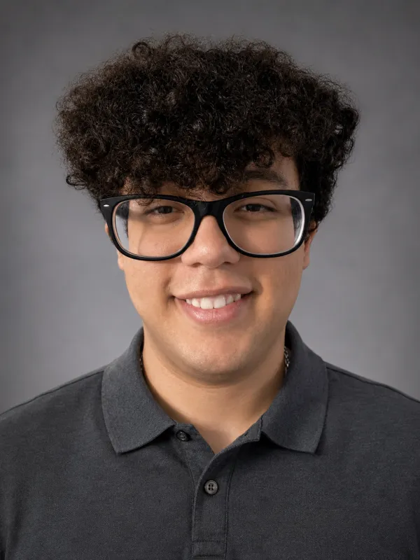 Budair standing in front of gray background