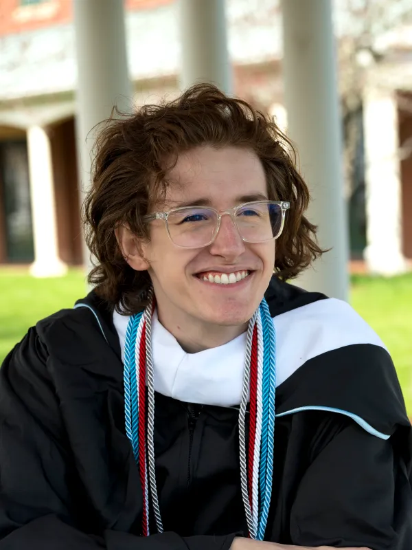 Emerson smiling in Graduation regalia